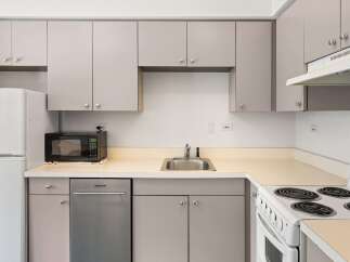 Discover this charming kitchen featuring sleek, modern cabinetry and a convenient countertop space perfect for meal preparation.