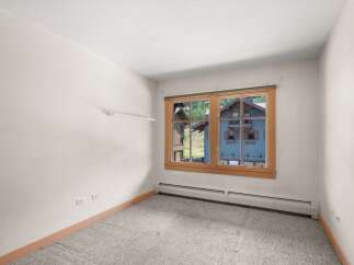 This room offers a bright and airy atmosphere, perfect for relaxation or a home office.
