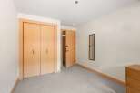 This bedroom features a spacious closet with double doors and a sleek, modern design.