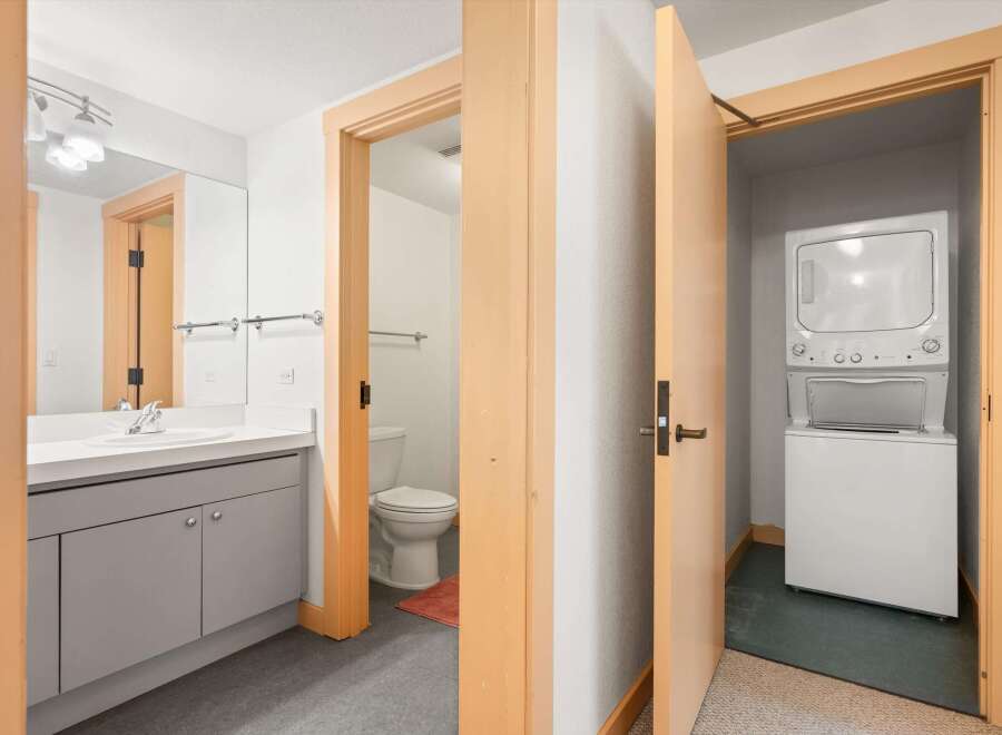 Discover modern convenience in this home, featuring a sleek bathroom with a vanity and a separate toilet area.
