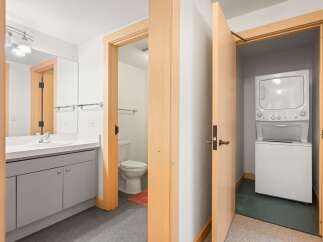 Discover modern convenience in this home, featuring a sleek bathroom with a vanity and a separate toilet area.