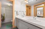 This modern bathroom features a double vanity with sleek chrome fixtures and ample counter space.