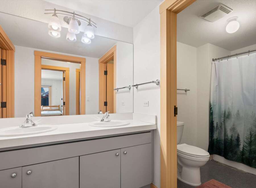 This modern bathroom features a spacious double vanity with sleek fixtures and ample counter space.