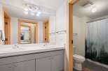 This modern bathroom features a spacious double vanity with sleek fixtures and ample counter space.
