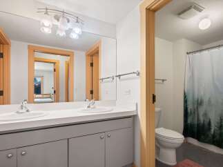 This modern bathroom features a spacious double vanity with sleek fixtures and ample counter space.