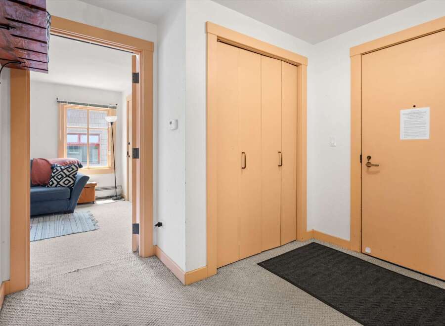 Step into this welcoming entryway featuring a convenient coat closet and a separate door leading to a cozy living area.