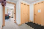 Step into this welcoming entryway featuring a convenient coat closet and a separate door leading to a cozy living area.