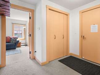 Step into this welcoming entryway featuring a convenient coat closet and a separate door leading to a cozy living area.