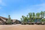 Discover this charming mountain village square, featuring a mix of rustic lodge-style architecture and modern amenities.