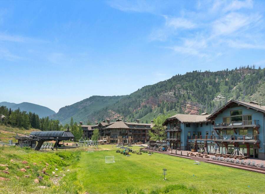 Experience luxury mountain living in this stunning property, featuring a ski lift and expansive green spaces perfect for outdoor activities.