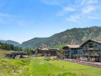 Experience luxury mountain living in this stunning property, featuring a ski lift and expansive green spaces perfect for outdoor activities.