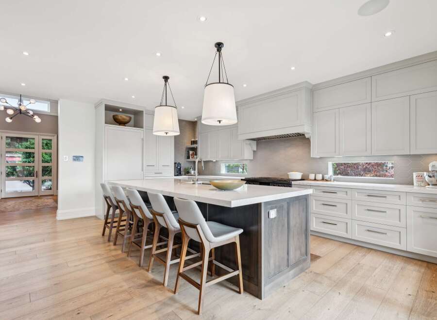 Experience luxury in this stunning modern kitchen, featuring a spacious island with comfortable bar seating perfect for entertaining.