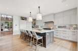 Experience luxury in this stunning modern kitchen, featuring a spacious island with comfortable bar seating perfect for entertaining.