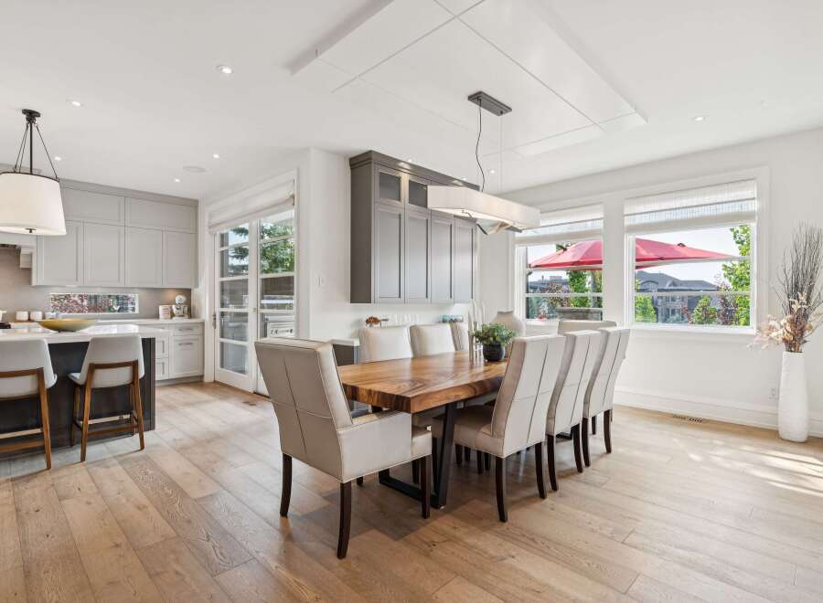 Experience elegant dining in this spacious open-concept home, featuring a stunning live-edge wood dining table perfect for gatherings.