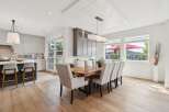 Experience elegant dining in this spacious open-concept home, featuring a stunning live-edge wood dining table perfect for gatherings.
