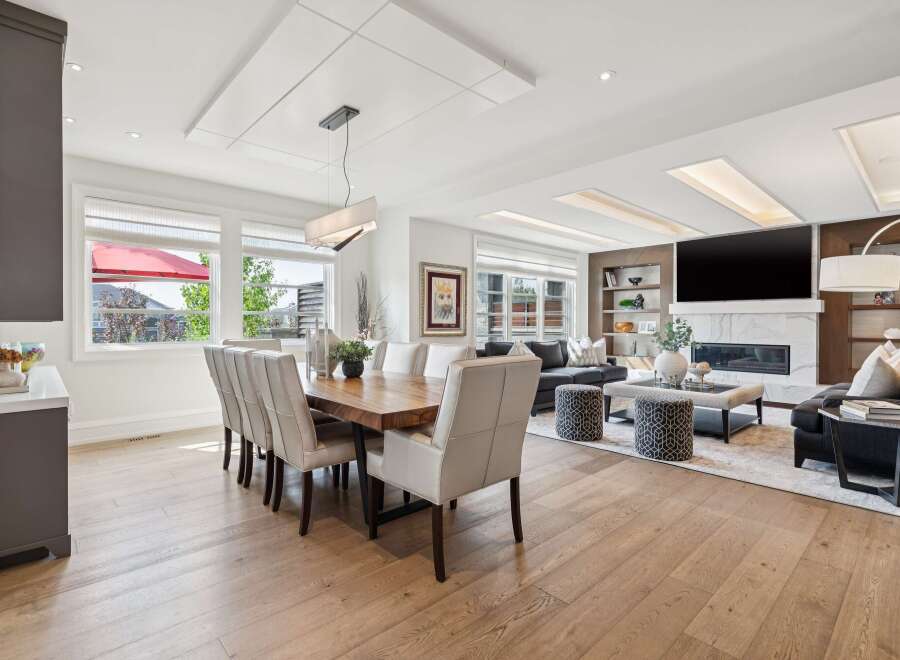 Experience luxury living in this open-concept dining and living area, featuring a stunning live-edge dining table and plush seating.