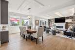 Experience luxury living in this open-concept dining and living area, featuring a stunning live-edge dining table and plush seating.