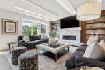 Experience luxury living in this stunning modern living room, featuring a sleek fireplace, a large flat-screen TV, and elegant built-in shelving.