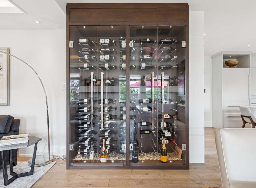 Experience luxury living with this stunning wine cellar, featuring a climate-controlled glass enclosure to perfectly preserve your collection.