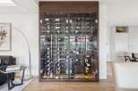 Experience luxury living with this stunning wine cellar, featuring a climate-controlled glass enclosure to perfectly preserve your collection.