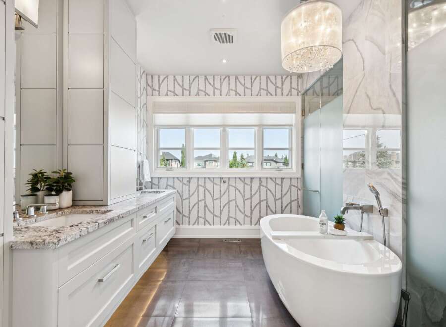 Experience luxury in this stunning bathroom featuring a freestanding soaking tub, perfect for unwinding after a long day.