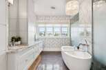 Experience luxury in this stunning bathroom featuring a freestanding soaking tub, perfect for unwinding after a long day.