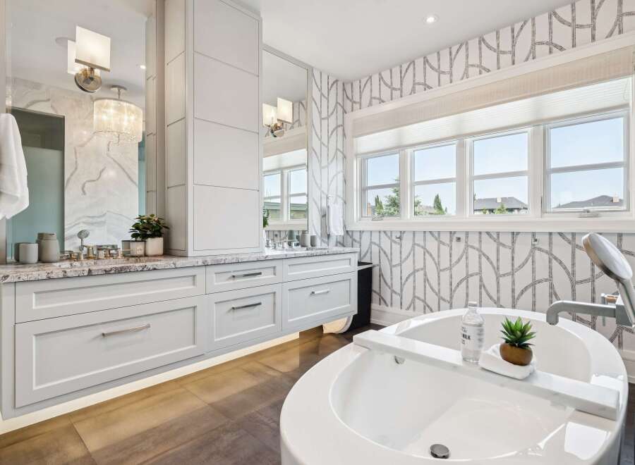 Indulge in luxury with this stunning bathroom featuring a spacious soaking tub and elegant vanity.