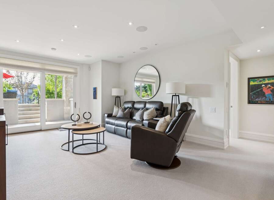 Step into this inviting living space featuring a plush leather sofa and a comfortable recliner, perfect for relaxation.