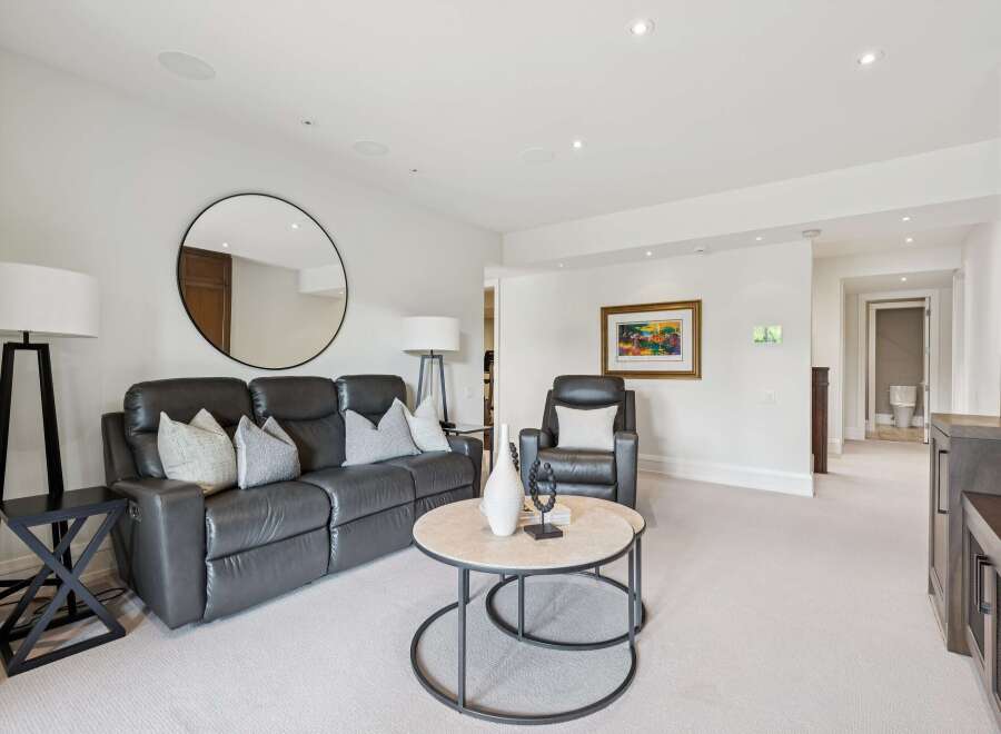 Experience ultimate comfort in this inviting living space, featuring plush leather seating and a stylish round coffee table perfect for gatherings.