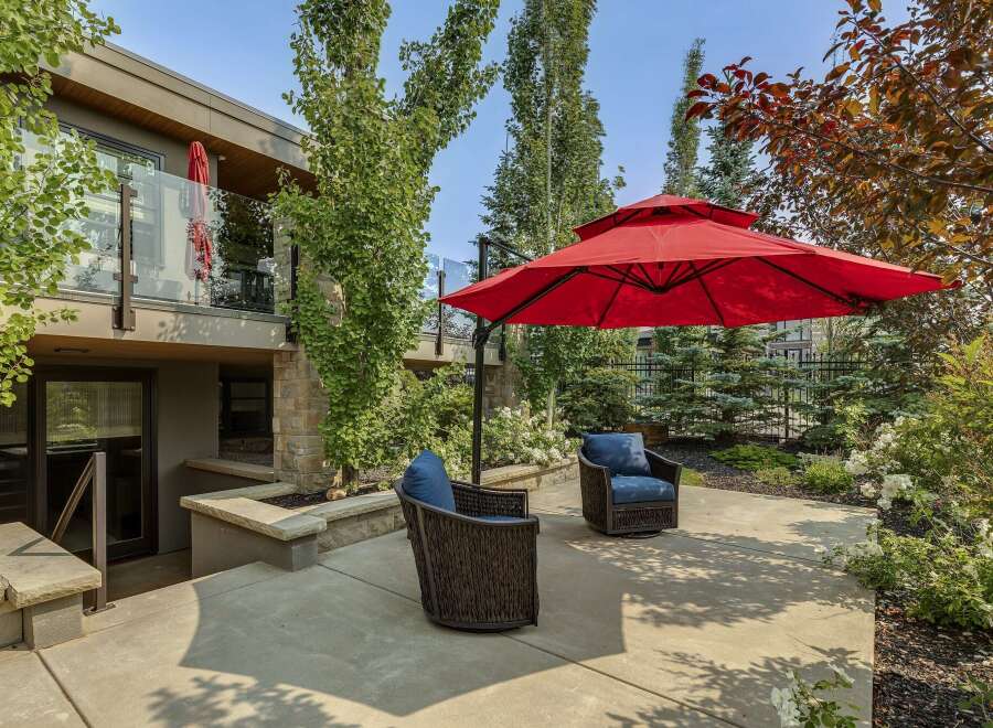 Enjoy outdoor living in this beautifully landscaped backyard featuring a spacious concrete patio perfect for entertaining.