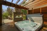 Experience ultimate relaxation in this luxurious backyard oasis, featuring a bubbling hot tub perfect for unwinding.