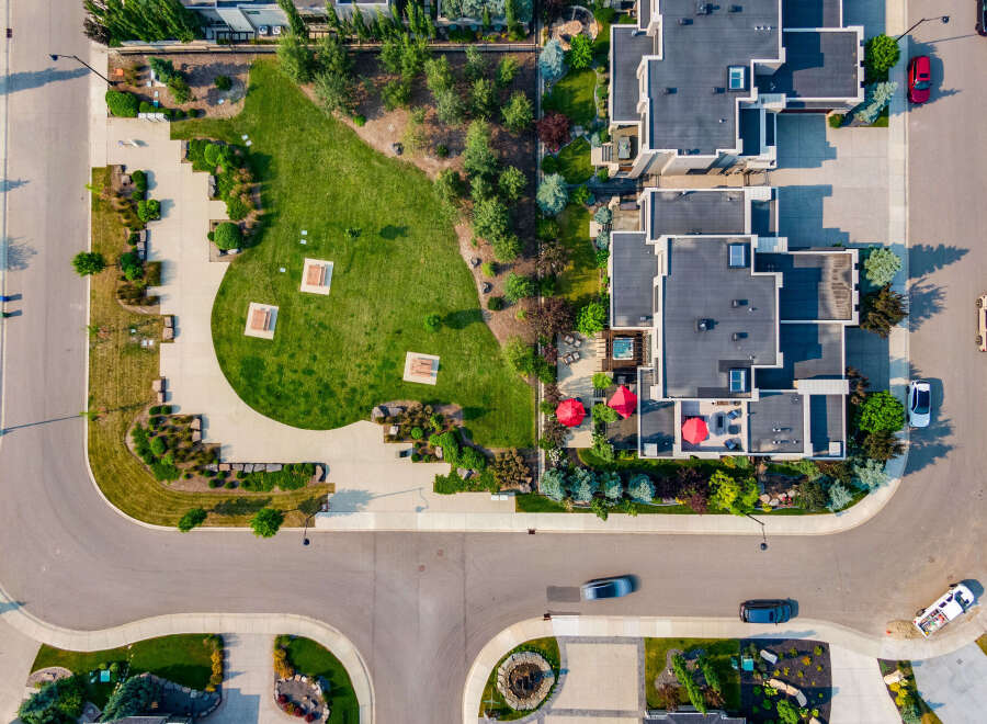 Experience luxury living in this stunning aerial view of a modern townhouse complex.