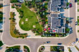 Experience luxury living in this stunning aerial view of a modern townhouse complex.