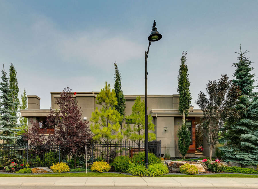 Discover modern luxury with this stunning home, featuring a sleek, contemporary facade complemented by lush, mature landscaping.