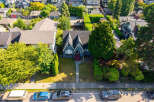 Discover this charming home featuring a distinctive dark blue exterior with a classic gabled roofline and inviting red-accented steps leading to the entrance.