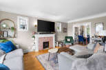 Step into this inviting living room featuring a cozy brick fireplace and a large flat-screen TV, perfect for entertainment.