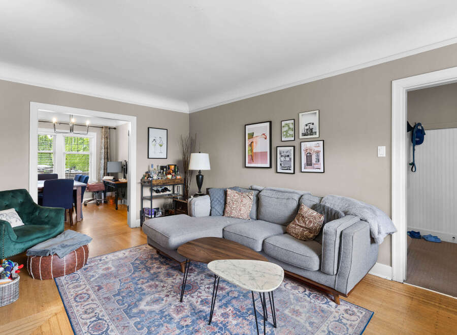 Step into this inviting living space, featuring a plush grey sectional sofa perfect for relaxation and entertaining.