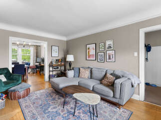 Step into this inviting living space, featuring a plush grey sectional sofa perfect for relaxation and entertaining.