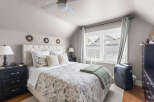 Discover this charming bedroom featuring a plush tufted headboard and a beautifully patterned duvet.