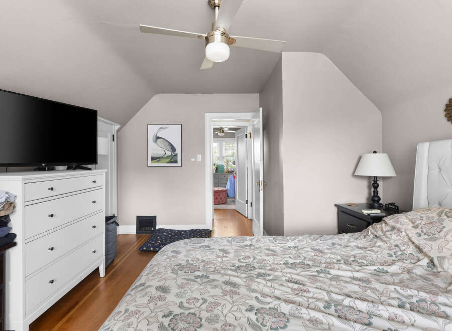 Discover this charming bedroom featuring a comfortable bed with a tufted headboard, perfect for relaxation.