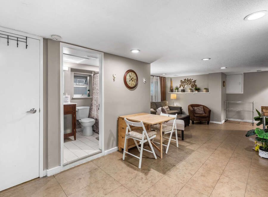 Discover this charming basement apartment featuring a compact dining area perfect for intimate meals.