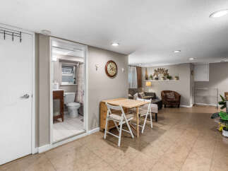 Discover this charming basement apartment featuring a compact dining area perfect for intimate meals.