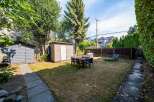 Enjoy outdoor living in this spacious backyard featuring a dining set perfect for al fresco meals and two lounge chairs for ultimate relaxation.