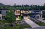 Discover modern mountain living in this stunning contemporary home, featuring a striking architectural design with natural wood and dark siding accents.
