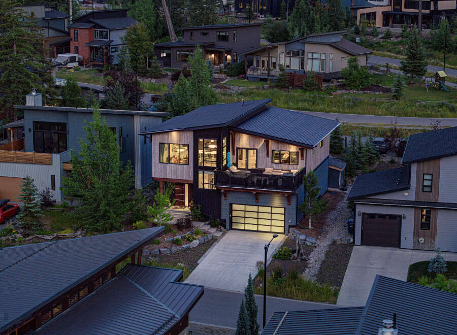 Experience modern luxury in this stunning multi-level home, featuring a sleek contemporary design with natural wood accents and expansive windows.