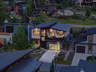 Experience modern luxury in this stunning multi-level home, featuring a sleek contemporary design with natural wood accents and expansive windows.