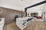 Experience modern luxury in this stunning open-concept kitchen and living area.