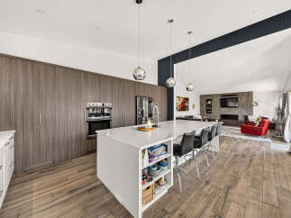 Experience modern luxury in this stunning open-concept kitchen and living area.