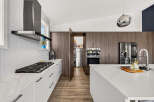 Experience modern luxury in this stunning kitchen, featuring sleek white cabinetry and a marble-patterned countertop.