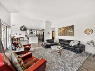 Experience modern living in this spacious open-concept home, featuring a sleek kitchen with a large island and a comfortable living area perfect for entertaining.